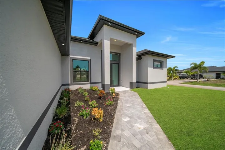 Modern exterior featuring a prominent entryway with an opaque glass door