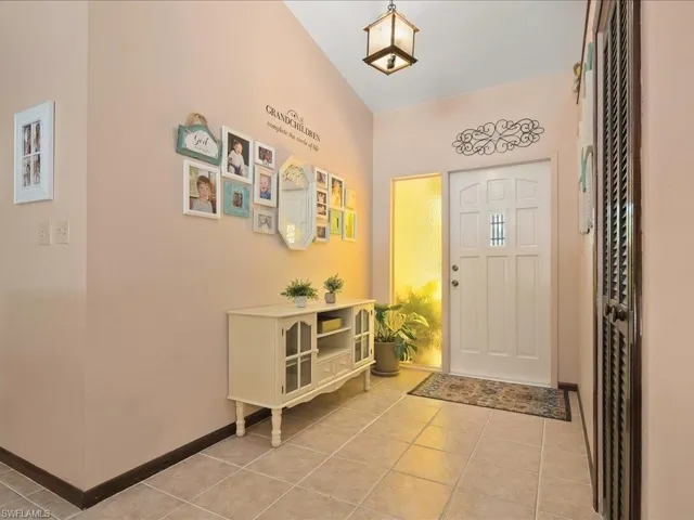Entryway featuring baseboards and light tile patterned flooring