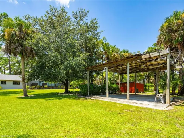 View of green lawn with a carport