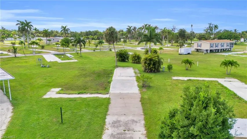 View of property's community with a lawn