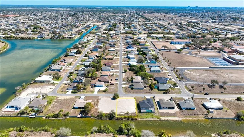 Aerial view of residential area featuring a large body of water
