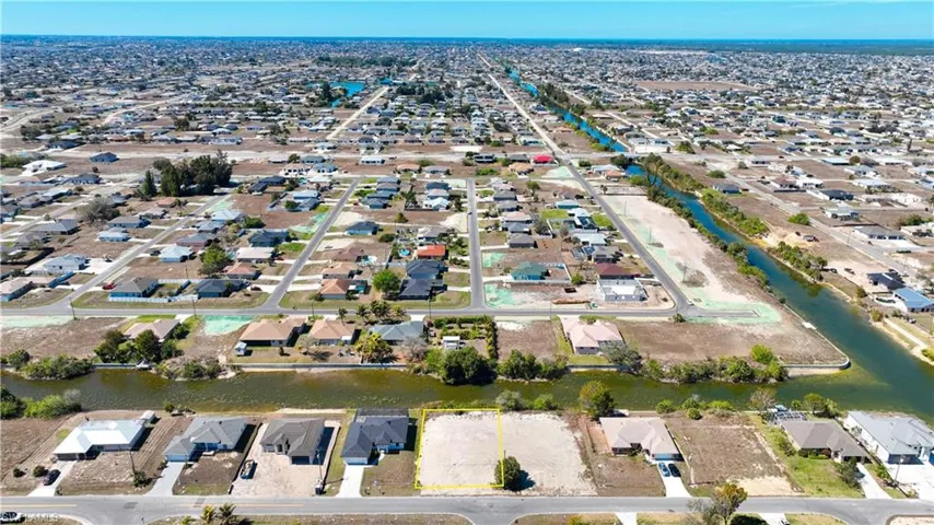 Aerial view of property's location with nearby suburban area and a nearby body of water