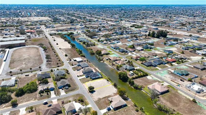 Aerial overview of property's location with a large body of water and nearby suburban area