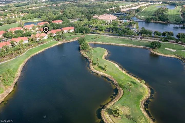 Birds eye view of property with a water view