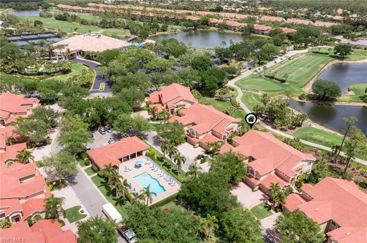 Drone / aerial view featuring a water view, view of golf course, and a residential view