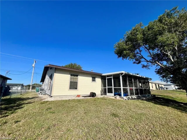 Back of property with a sunroom