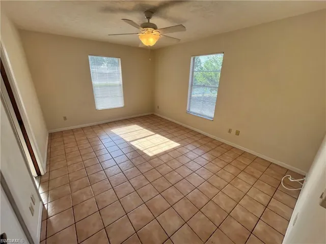 Spare room featuring light tile patterned flooring and a ceiling fan