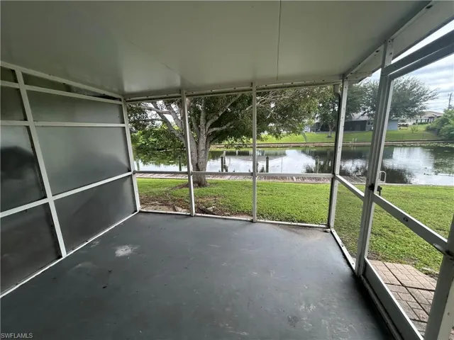 Unfurnished sunroom featuring a water view