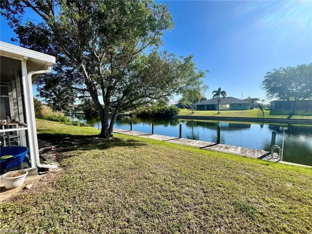 View of grassy yard with a water view