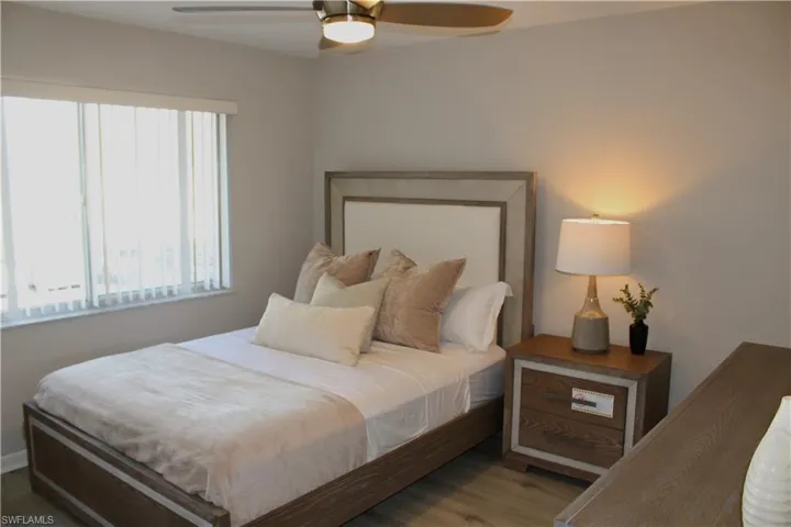 Bedroom with ceiling fan and wood finished floors
