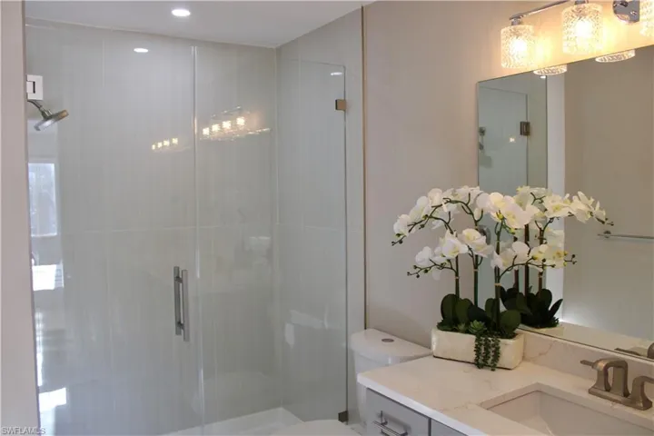 Full bath with a stall shower and vanity