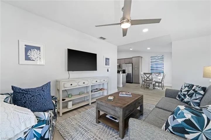 Living room with a ceiling fan and light wood-style floors
