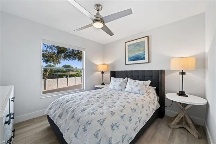 Bedroom with light wood-style flooring and a ceiling fan