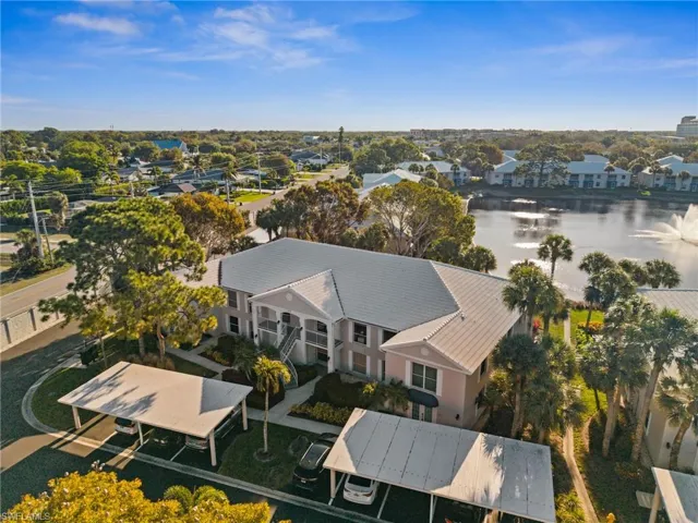 Aerial perspective of suburban area featuring a nearby body of water