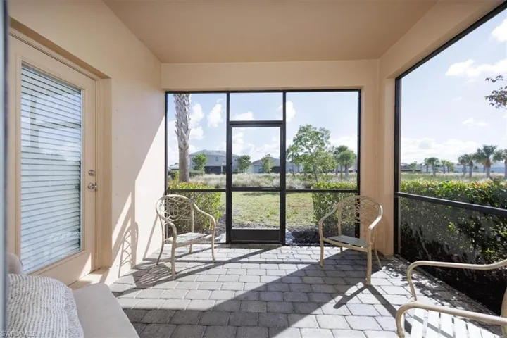 View of sunroom / solarium  Notice large expanse of common area separating neighbors to the rear for added privacy