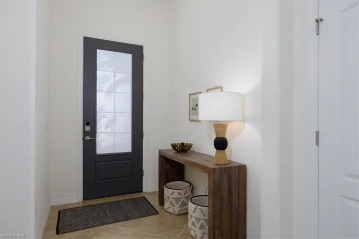 Foyer featuring tile patterned floors and baseboards high Ceilings with Crown moldings