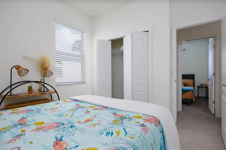 Carpeted Queen bedroom featuring a closet and Queen Bed