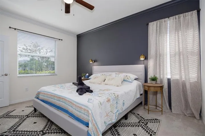Owners Bedroom featuring ornamental molding and ceiling fan, Full bath, and walk in closet