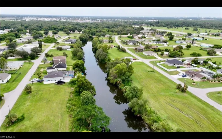 Aerial perspective of suburban area featuring a large body of water