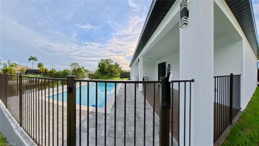 View of swimming pool with a balcony