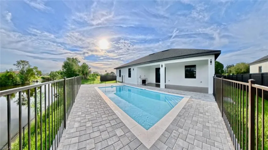 View of pool with a patio area and a fenced backyard