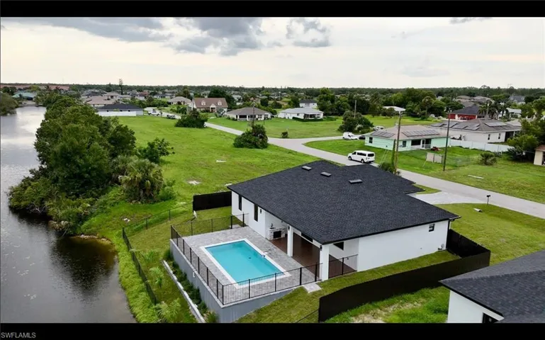 Aerial view of residential area featuring a large body of water