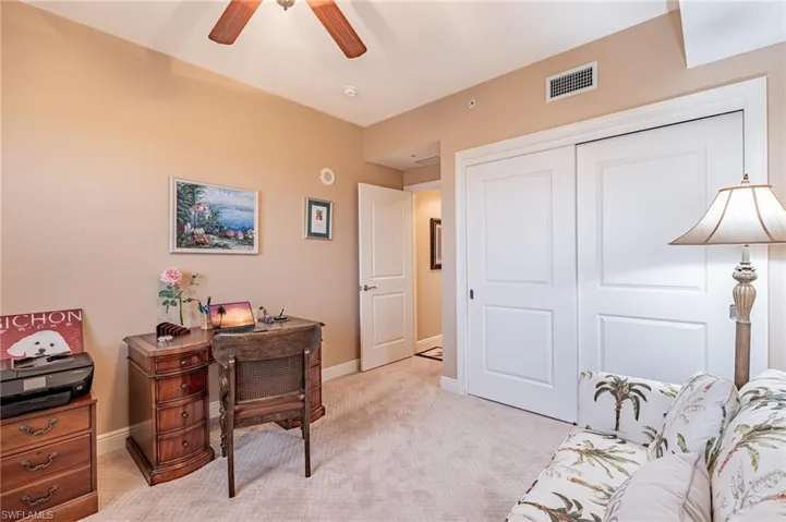 Office space featuring ceiling fan and light colored carpet