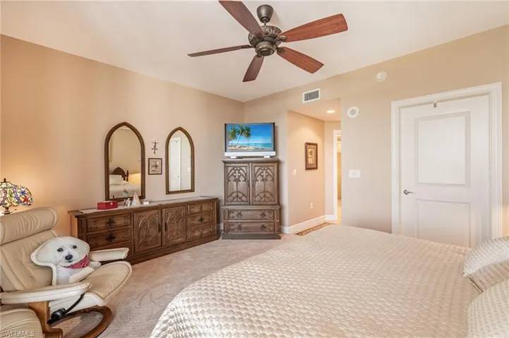 Carpeted bedroom with ceiling fan