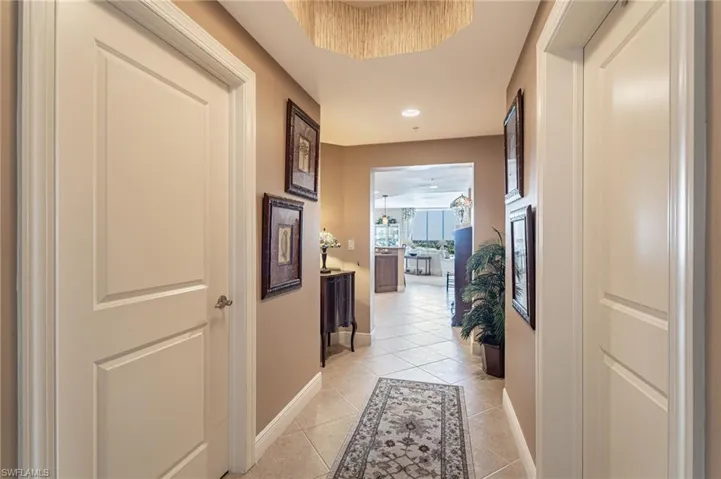 Hallway featuring light tile patterned floors
