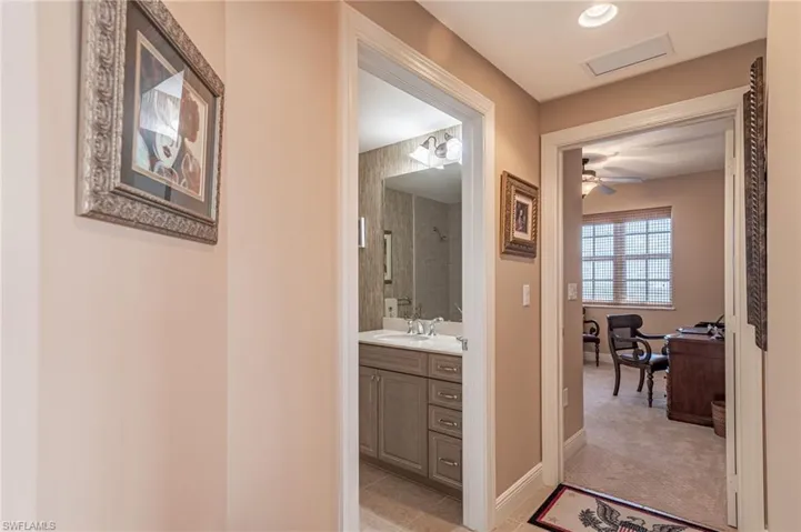 Hall featuring sink and light tile patterned flooring