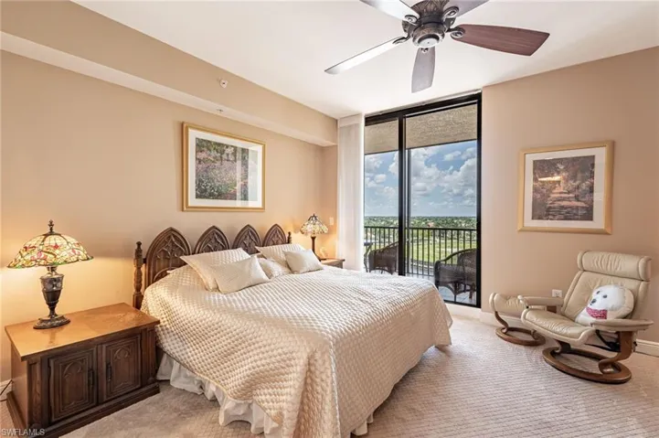 Bedroom featuring carpet flooring, access to outside, a wall of windows, and ceiling fan