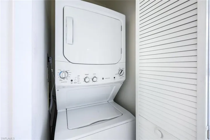 Laundry area featuring stacked washer / dryer