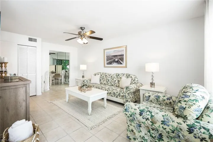 Tiled living room featuring ceiling fan