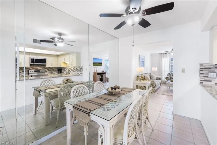 Tiled dining area featuring ceiling fan