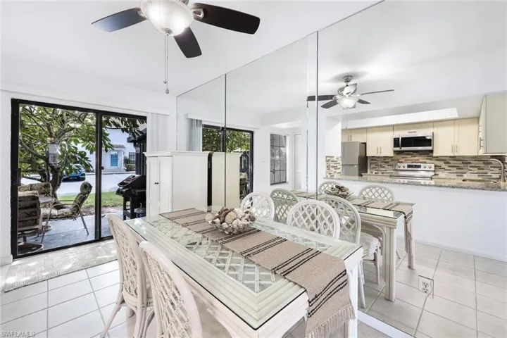 Dining area featuring sink, light tile patterned flooring, and ceiling fan