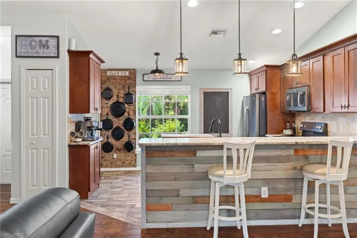 Kitchen with tasteful backsplash, stainless steel appliances
