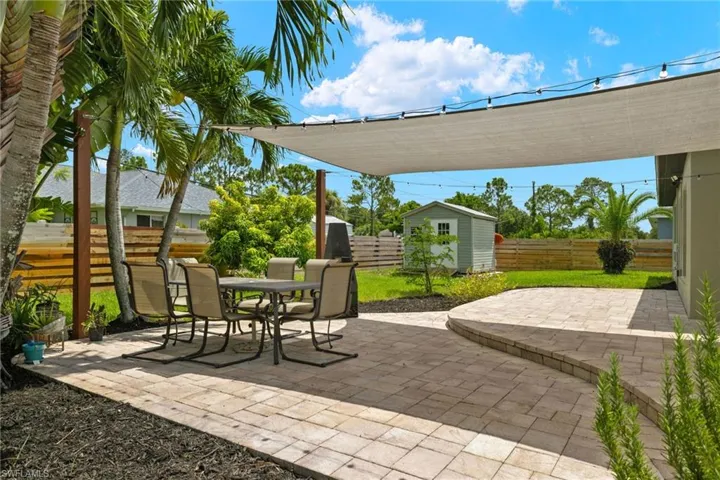 View of patio featuring a shed