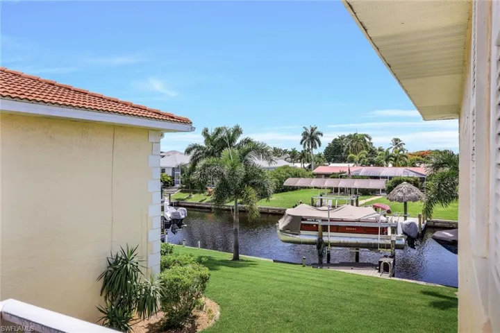 View of dock featuring a water view and a lawn