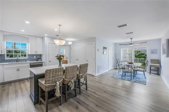 Dining area with light hardwood / wood-style floors, sink, a healthy amount of sunlight, and ceiling fan