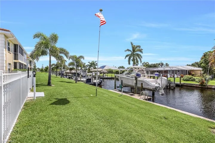View of dock featuring a water view and a yard