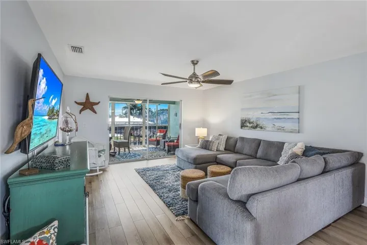 Living room featuring ceiling fan and wood-type flooring