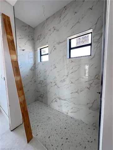 Full bathroom featuring a marble finish shower