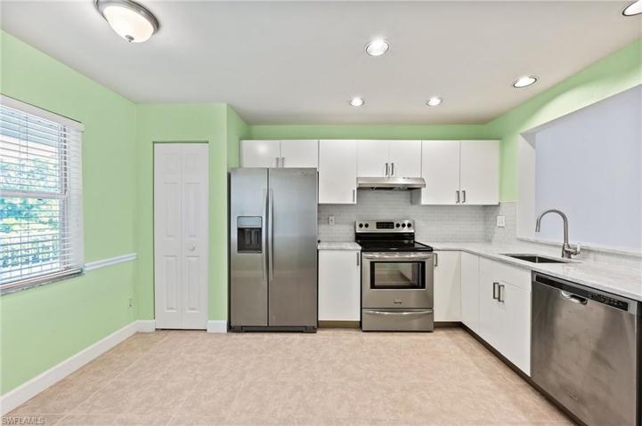 Granite Counters, White Cabinetry and Stainless Steel Appliances
