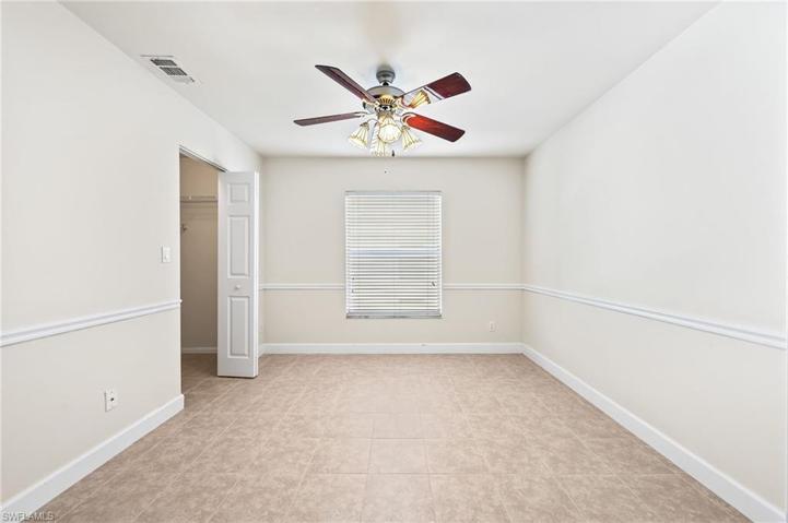 Tiled Bedroom/Den with Chair Rail and Window
