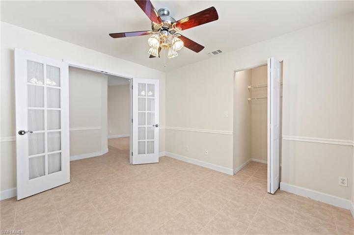 Bedroom/Den with Chair Rail and Glassed French Doors