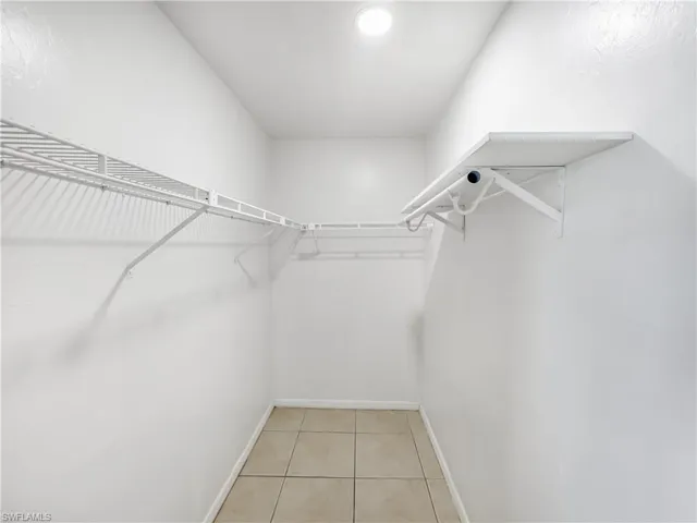 Walk in closet featuring light tile patterned flooring