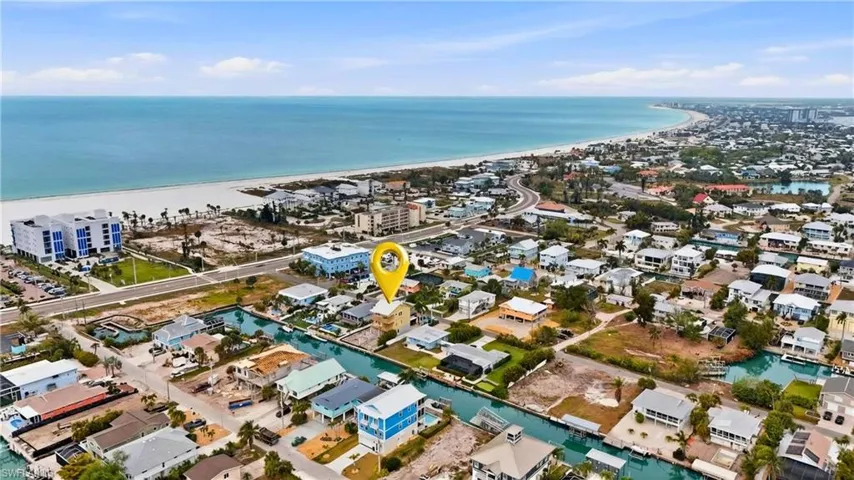 Aerial perspective of suburban area with a nearby body of water  - Virtually Edited Image