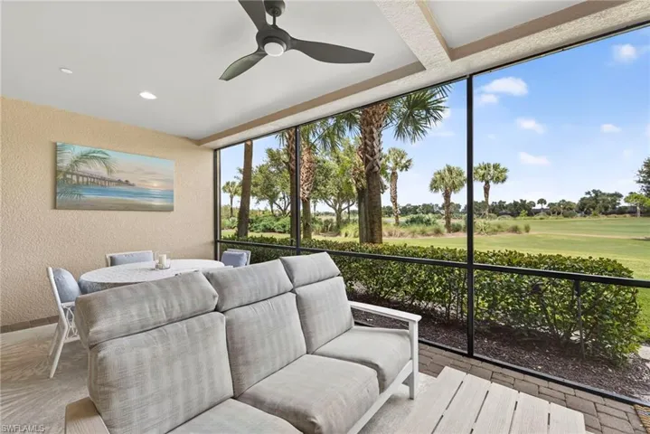 Sunroom featuring a ceiling fan, golf course view, and an outdoor hangout area