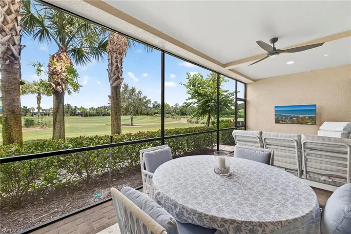 Sunroom / solarium featuring outdoor dining area, ceiling fan, a textured wall, recessed lighting, and an outdoor hangout area