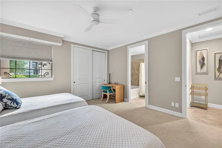 Bedroom with carpet flooring, ornamental molding, ceiling fan, and a closet